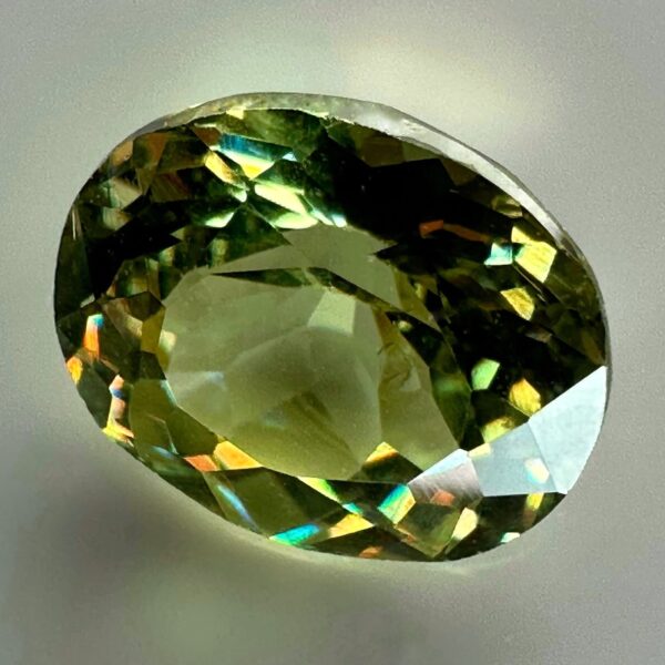 0.48 carat natural demantoid garnet from Namibia, light bright green color, beautiful clarity, and brilliance.