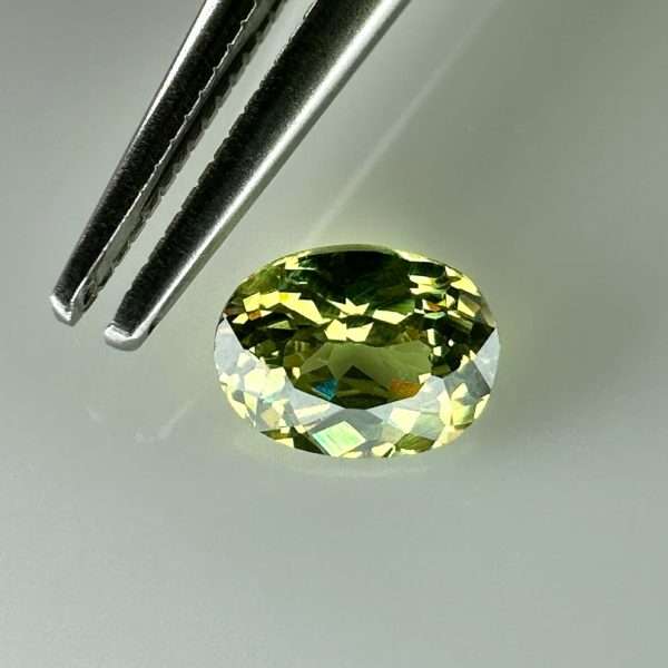 0.46 carat natural demantoid garnet from Namibia, bright green color, eye-clean clarity, and exceptional brilliance.