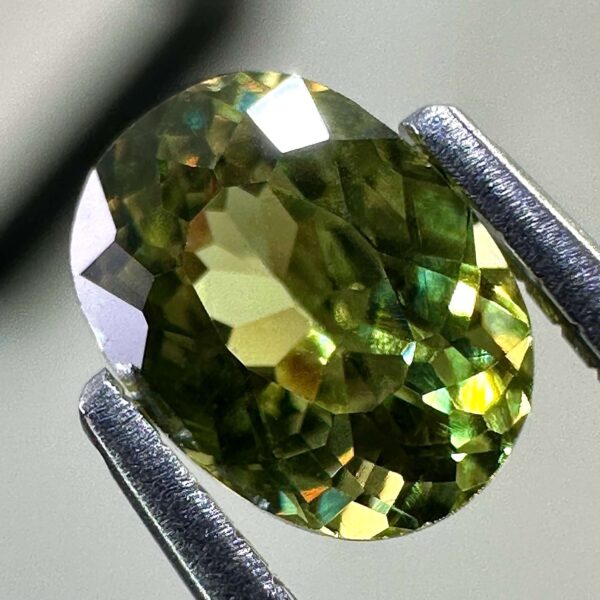 0.46 carat natural demantoid garnet from Namibia, bright green color, eye-clean clarity, and exceptional brilliance.