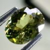 0.46 carat natural demantoid garnet from Namibia, bright green color, eye-clean clarity, and exceptional brilliance.
