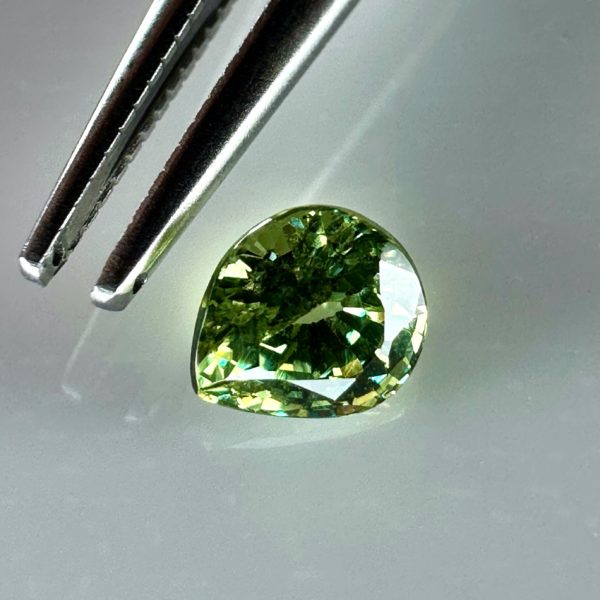 0.43 carat natural demantoid garnet from Namibia, bright green color, and excellent clarity.