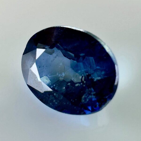 Natural blue sapphire 0.87 ct, oval cut, navy blue color, Thailand origin, jewelry quality gemstone with very few inclusions.