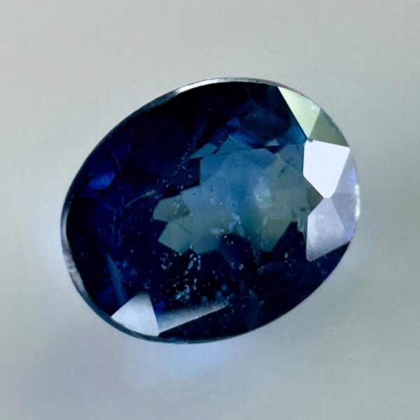 Natural blue sapphire 0.87 ct, oval cut, navy blue color, Thailand origin, jewelry quality gemstone with very few inclusions.